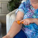 Woman using Flow Vibe II on her arm